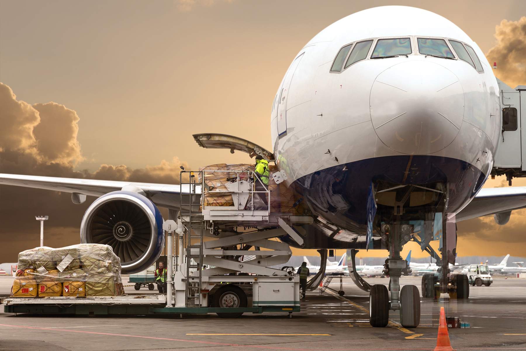 Air cargo pallets being loaded through the nose door of a freighter aircraft